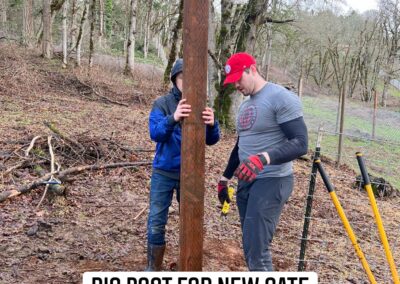 Installing a new fence post at Osher Farm